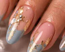 Illustrative study of blue-grey and nude nails with gold foil and a pearl. Not work from this parlor.