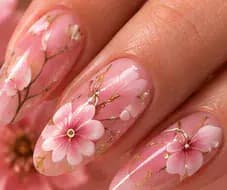 Illustrative study of pink nails painted with blossoms and gold stems. Not work from this parlor.